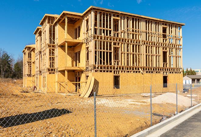 a temporary chain link fence winding around a construction site, outlining the project's progress in Jeromesville, OH